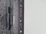 the back of a black box with a red and white label on it