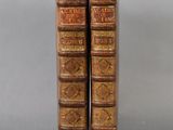 a pair of old books sitting on top of each other
