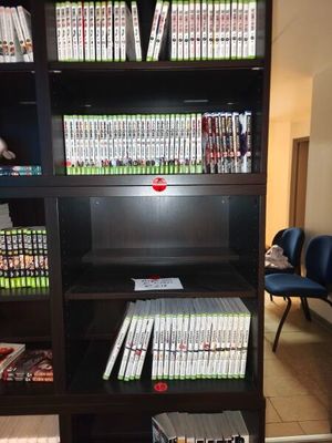 a book shelf that has a lot of books on it