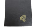 a black book with a gold heart on top of it