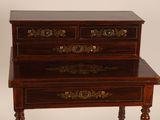 a small table with three drawers on top of it