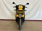 yellow and black motorcycle parked in front of a white backdrop