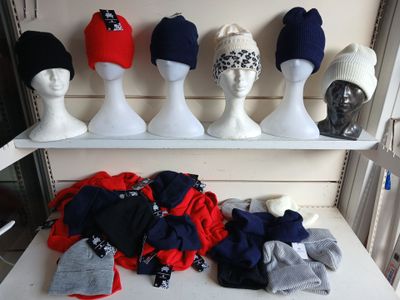 many hats on display on a shelf in a store