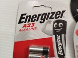 two piles of batteries sitting on top of a table next to each other