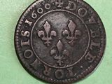a close up of an old coin on a green surface