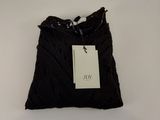 the black bag is hanging on the wall with a tag on it