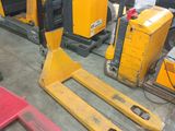 a fork lift truck parked in a warehouse next to other pallets