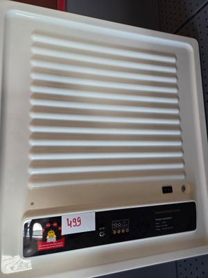 a white air conditioner on a shelf in a store