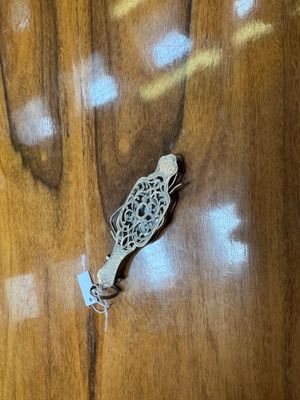 a small metal object on a wooden table