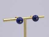 pair of lapis and diamond earrings on a gold plated stand