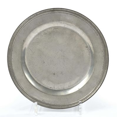 an antique silver plate on a stand on a white background