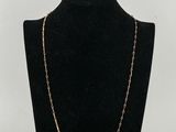 a black mannequin with a gold chain on it