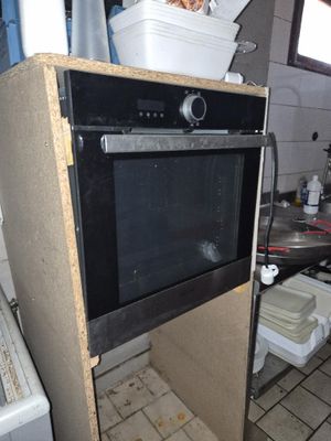 a black oven sitting on top of a counter in a kitchen