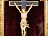 a close up of a crucifix with a cat on it