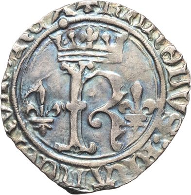 une pièce d'argent surmontée d'une couronne