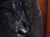 a statue of a bird that is on the wall