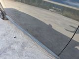 a black car parked on the side of the road