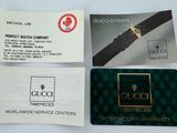 three business cards and a watch are sitting on a table