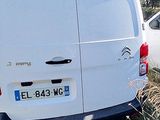 a white van that is parked on the side of the road