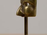 an image of a bronze sculpture of a man ' s head on a wooden base