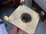 a person holding a small metal object in their hand