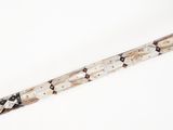 a close up of a long knife on a white surface