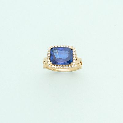 an image of a blue sapphire and diamond ring on a white surface