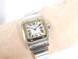 a silver and gold watch on a woman ' s wrist