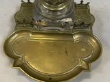 an antique brass plate with an ornate design on it