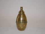 a small brass object on a white surface