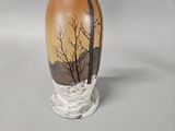a vase with a picture of a tree on it