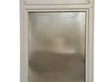 a mirror in the middle of a white cabinet