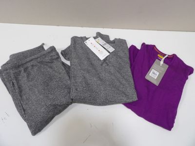trois paires de vêtements pour femmes posées sur une table blanche