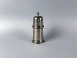 a small silver pepper shaker on a white surface
