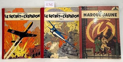 three books are lined up on a white surface, one is a plane and the other is a plane