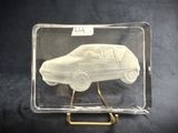 a clear box with a car in it on a stand