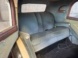 a couch in the back of a car with a window open