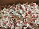 a cardboard box filled with a lot of packets of food