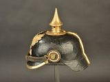 a black helmet with a gold decoration on it