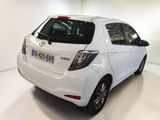 a white toyota yaris parked in a white room