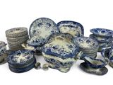 many blue and white plates and bowls on the table