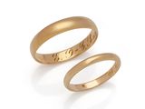 a pair of gold wedding rings with engraved names
