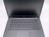 an open laptop computer sitting on top of a white table