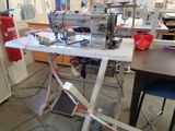 a sewing machine that is sitting on a table in a room
