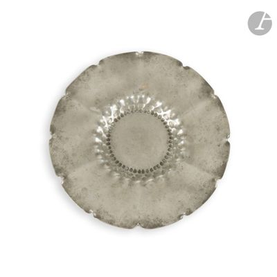 a silver plate with a circular design on it