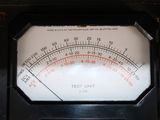 a close up of an analog meter on a table
