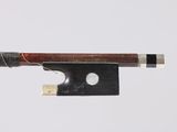 a close up of a violin bow with a piece of wood sticking out of it