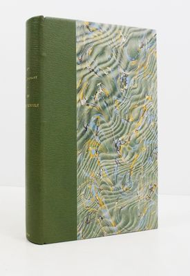 a book with a green cover sitting on top of a white table