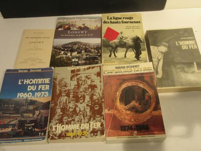 several books on display on a table with a red arrow pointing up