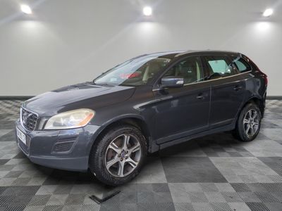 a gray volvo suv parked in a garage with a checkered floor
